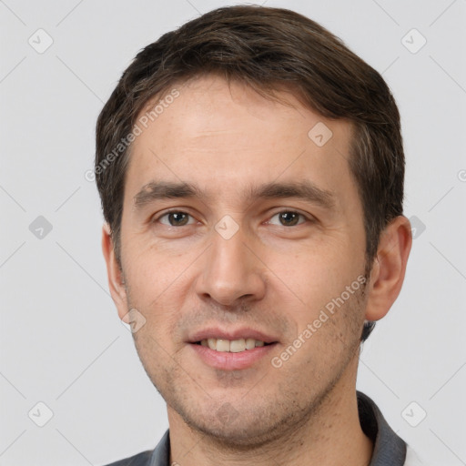 Joyful white adult male with short  brown hair and brown eyes