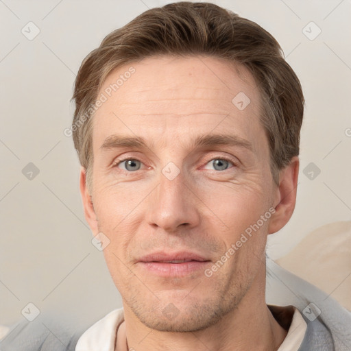 Joyful white adult male with short  brown hair and grey eyes