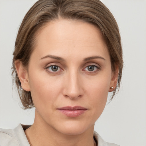 Joyful white young-adult female with medium  brown hair and grey eyes