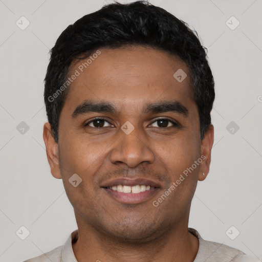 Joyful black young-adult male with short  black hair and brown eyes
