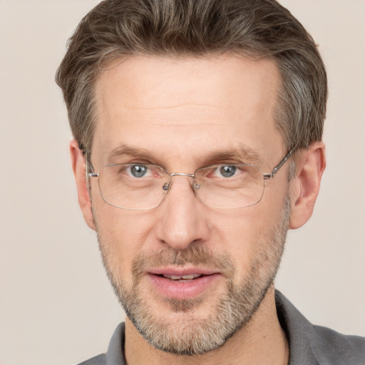 Joyful white adult male with short  brown hair and grey eyes