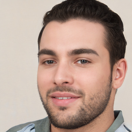 Joyful white young-adult male with short  black hair and brown eyes