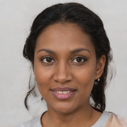 Joyful black young-adult female with medium  brown hair and brown eyes