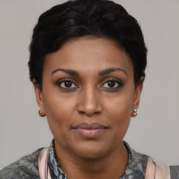 Joyful latino young-adult female with short  black hair and brown eyes