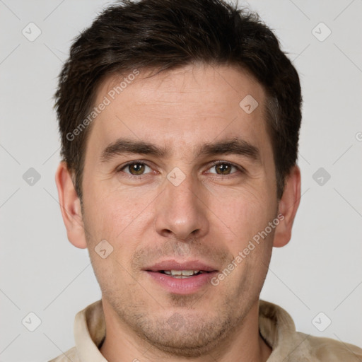 Joyful white young-adult male with short  brown hair and grey eyes