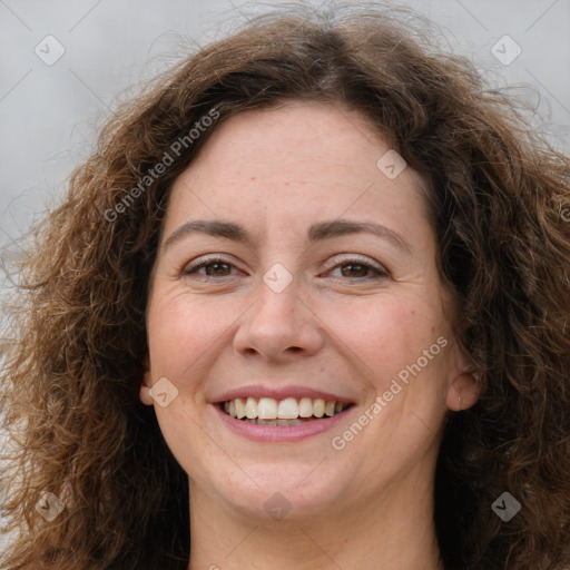 Joyful white adult female with long  brown hair and brown eyes