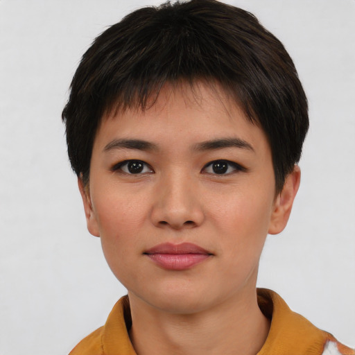 Joyful asian young-adult female with short  brown hair and brown eyes