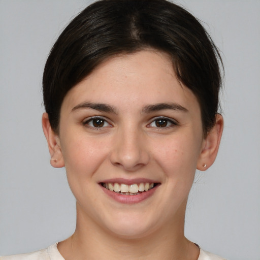 Joyful white young-adult female with medium  brown hair and brown eyes