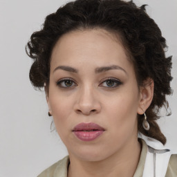 Joyful latino young-adult female with medium  brown hair and brown eyes