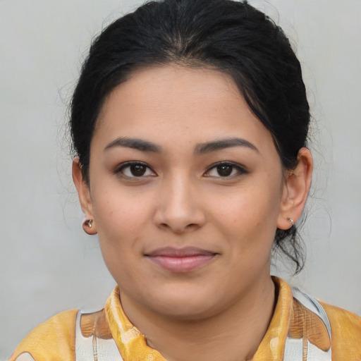 Joyful latino young-adult female with medium  brown hair and brown eyes