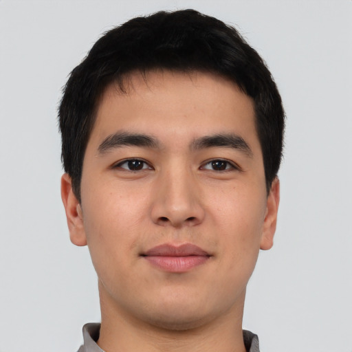 Joyful asian young-adult male with short  black hair and brown eyes