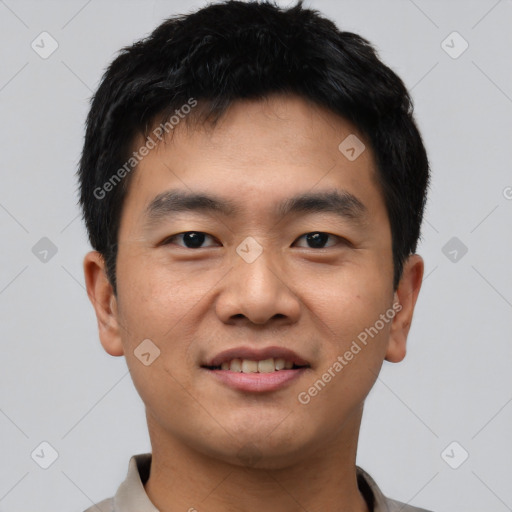 Joyful asian young-adult male with short  black hair and brown eyes