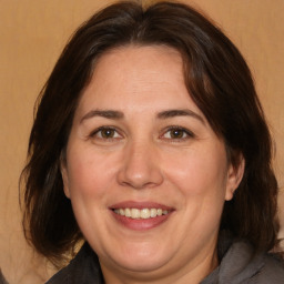 Joyful white adult female with medium  brown hair and brown eyes