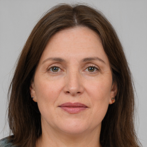 Joyful white adult female with long  brown hair and brown eyes