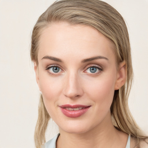 Joyful white young-adult female with medium  brown hair and green eyes