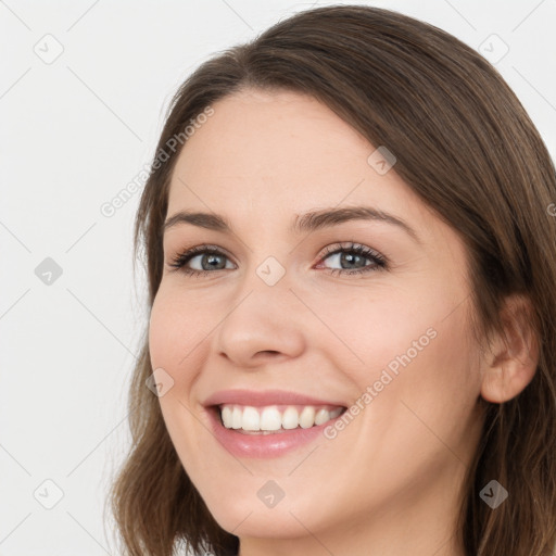 Joyful white young-adult female with long  brown hair and green eyes