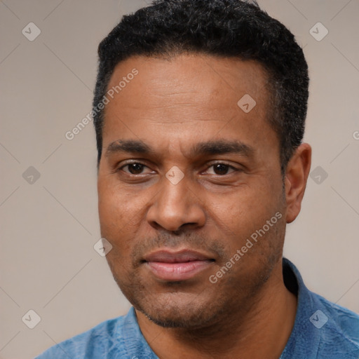 Joyful latino adult male with short  black hair and brown eyes