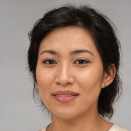 Joyful asian adult female with medium  brown hair and brown eyes