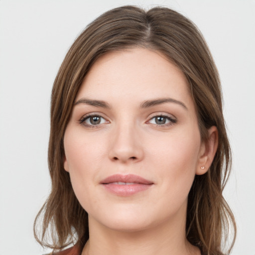 Joyful white young-adult female with long  brown hair and grey eyes