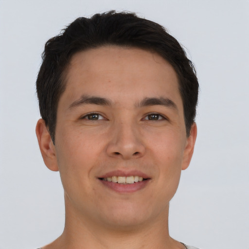 Joyful asian young-adult male with short  brown hair and brown eyes