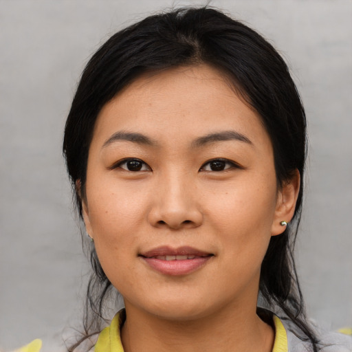 Joyful asian young-adult female with medium  brown hair and brown eyes