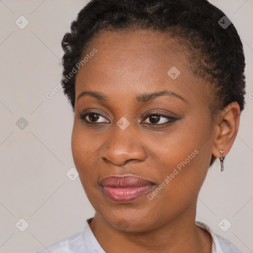 Joyful black young-adult female with short  brown hair and brown eyes