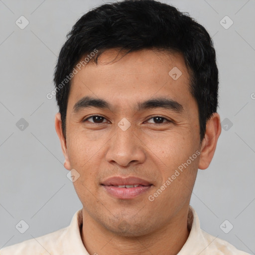 Joyful white young-adult male with short  black hair and brown eyes