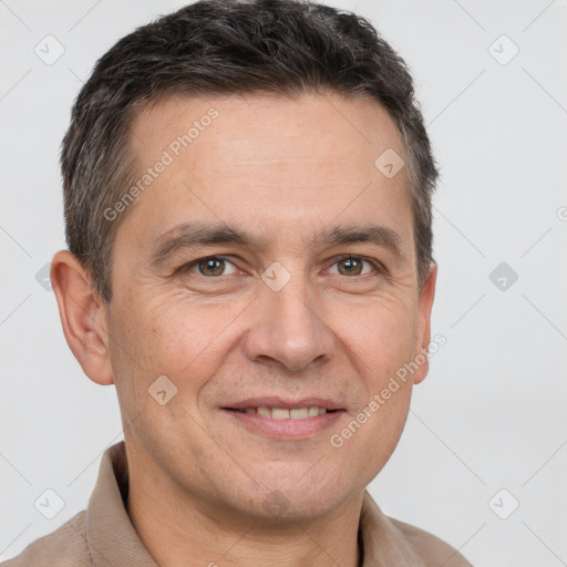 Joyful white adult male with short  brown hair and brown eyes