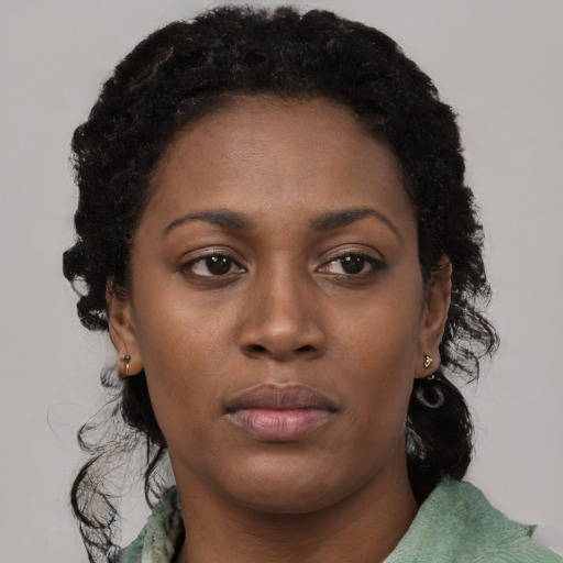 Neutral black young-adult female with long  brown hair and brown eyes