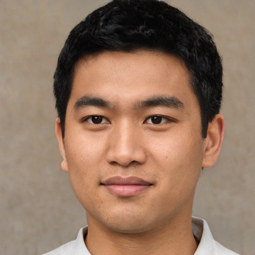 Joyful asian young-adult male with short  black hair and brown eyes