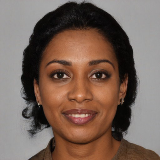 Joyful black young-adult female with medium  black hair and brown eyes