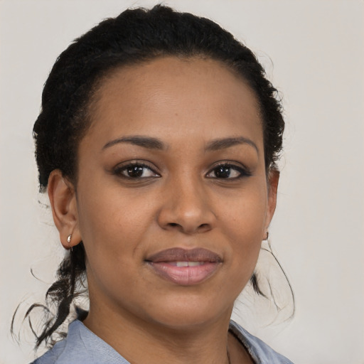 Joyful black young-adult female with medium  brown hair and brown eyes