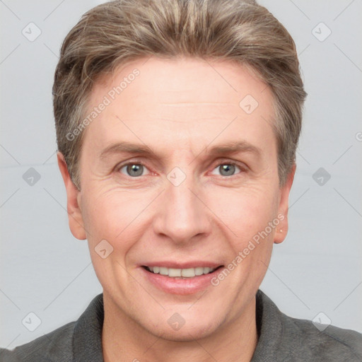 Joyful white adult male with short  brown hair and grey eyes