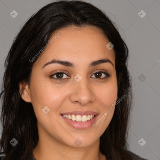 Joyful latino young-adult female with long  brown hair and brown eyes