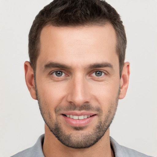 Joyful white young-adult male with short  brown hair and brown eyes