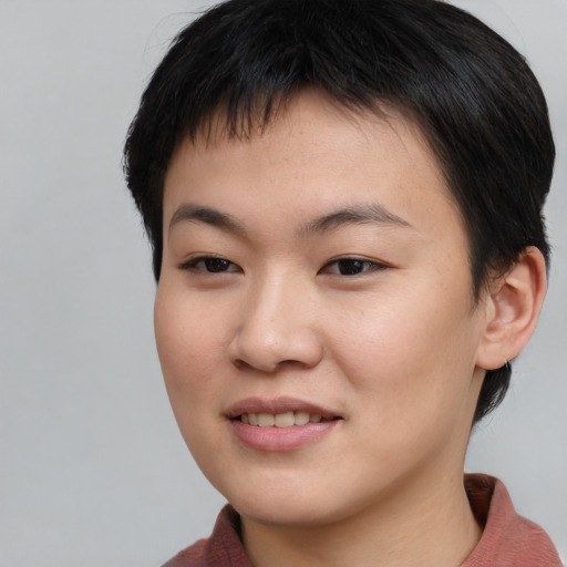 Joyful asian young-adult female with short  brown hair and brown eyes