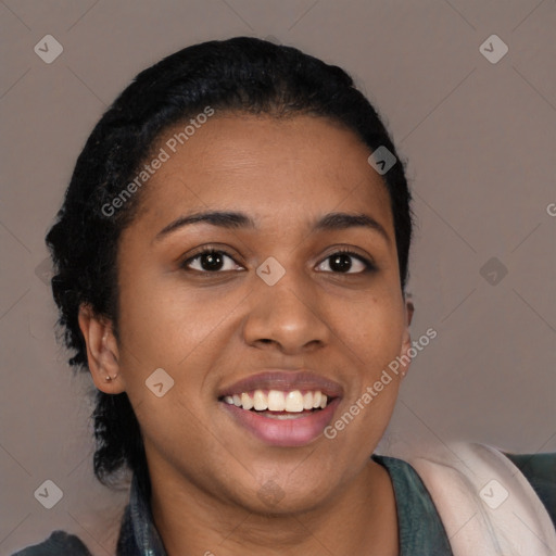 Joyful black young-adult female with long  black hair and brown eyes