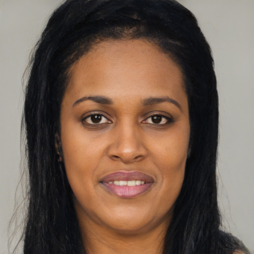 Joyful latino young-adult female with long  black hair and brown eyes