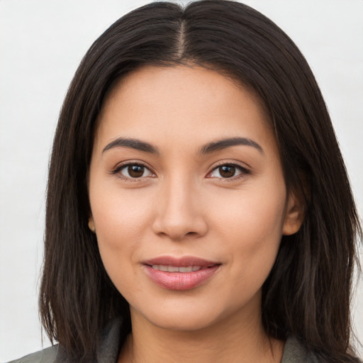 Joyful asian young-adult female with long  brown hair and brown eyes