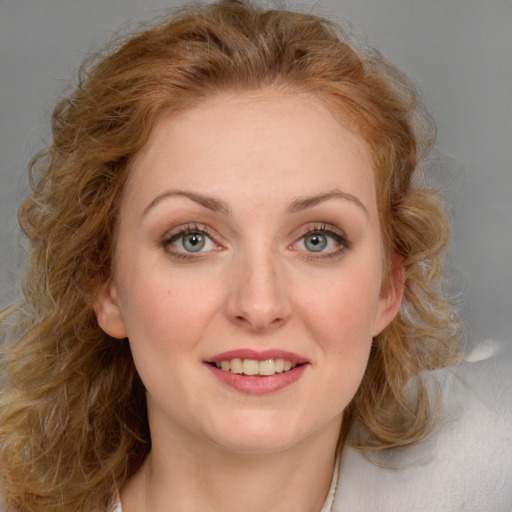 Joyful white young-adult female with medium  brown hair and blue eyes