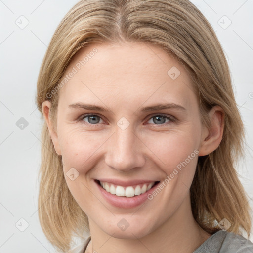 Joyful white young-adult female with long  brown hair and blue eyes