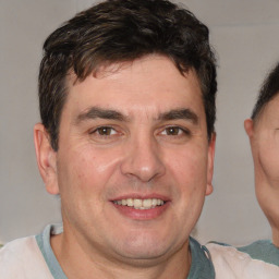 Joyful white adult male with short  brown hair and brown eyes