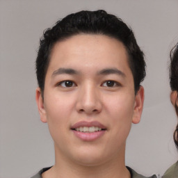 Joyful asian young-adult male with short  black hair and brown eyes