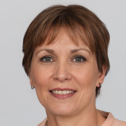 Joyful white adult female with medium  brown hair and grey eyes