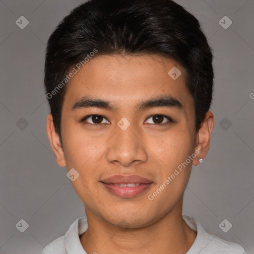 Joyful asian young-adult male with short  brown hair and brown eyes