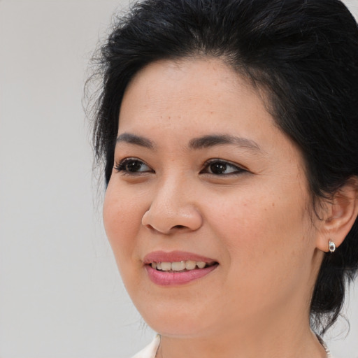 Joyful asian young-adult female with medium  brown hair and brown eyes
