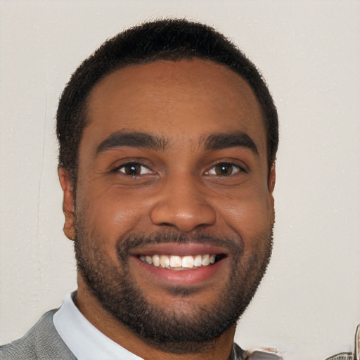 Joyful black young-adult male with short  brown hair and brown eyes