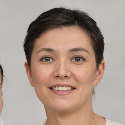 Joyful white young-adult female with short  brown hair and brown eyes