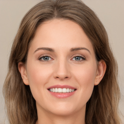 Joyful white young-adult female with long  brown hair and grey eyes