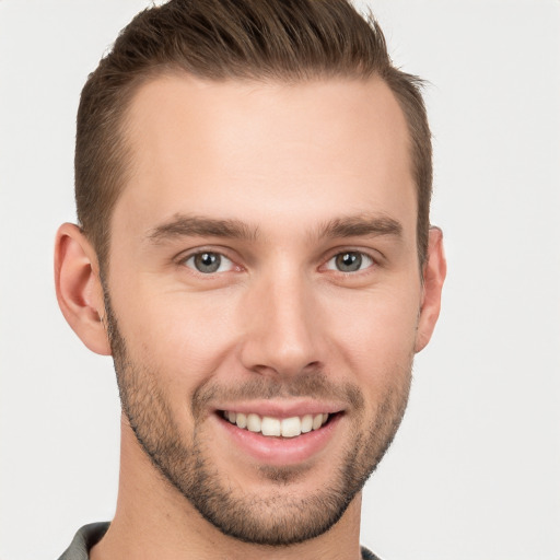 Joyful white young-adult male with short  brown hair and brown eyes